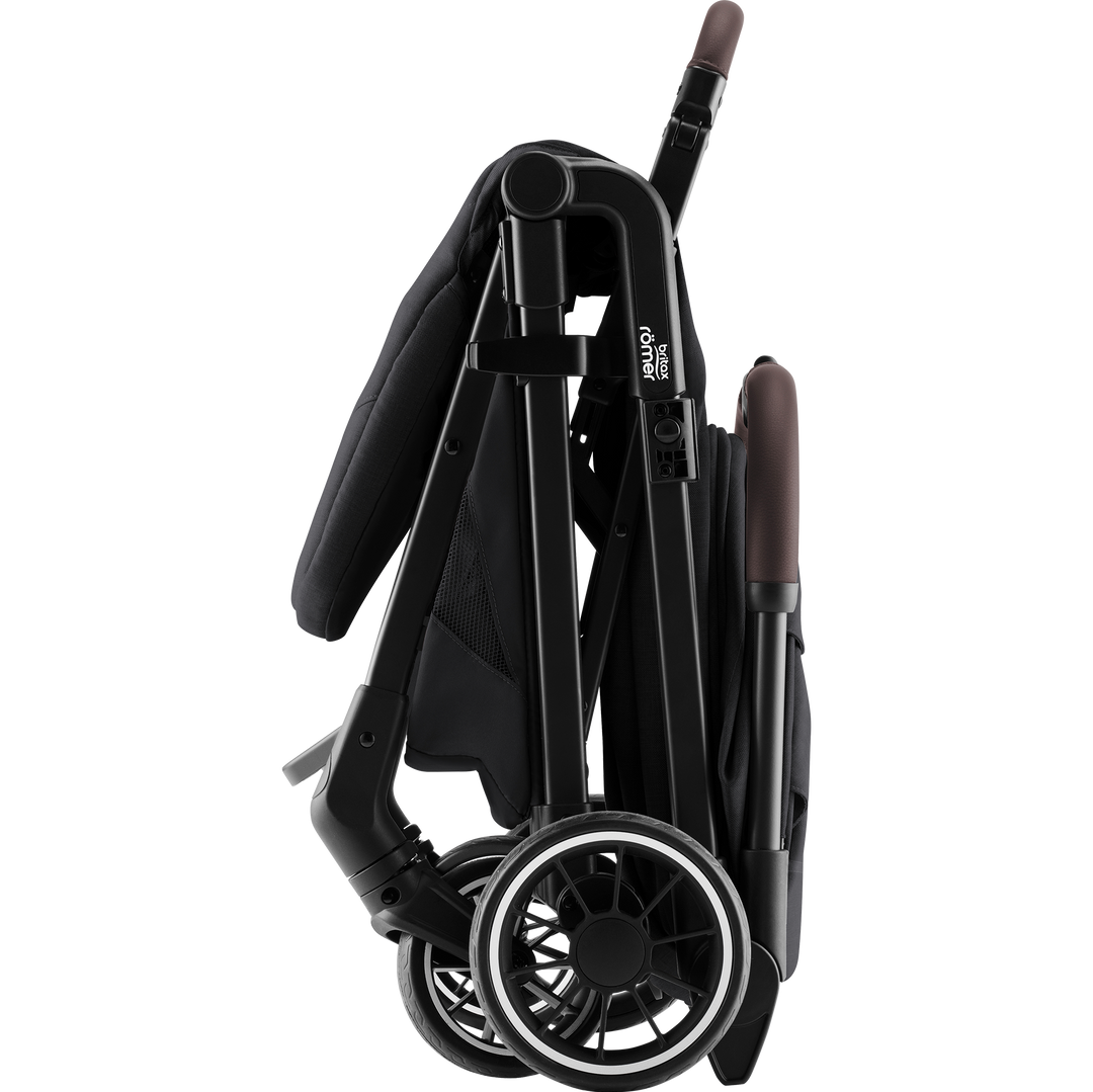 Britax Römer TIRA Carbon Black folded into its compact free-standing position
